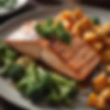 A wholesome plate of grilled salmon accompanied by steamed broccoli and sweet potatoes