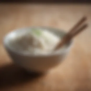 A bowl of white rice with chopsticks