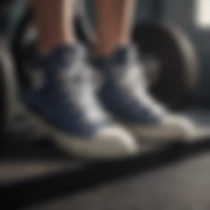 A close-up of Converse shoes on a weight lifting platform